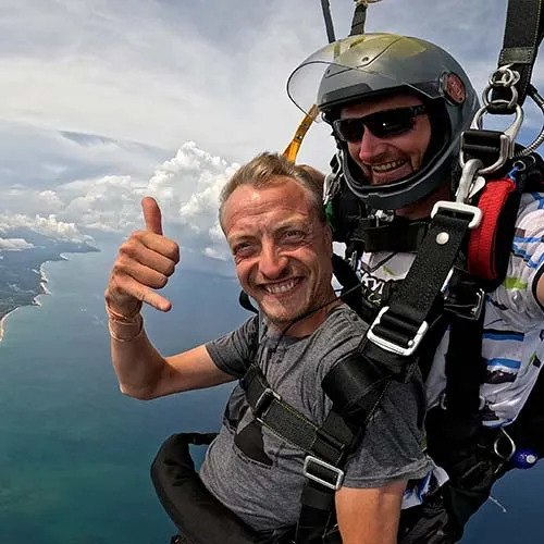 passenger and skydive sri lanka instructor flying a parachute over Bentota beach