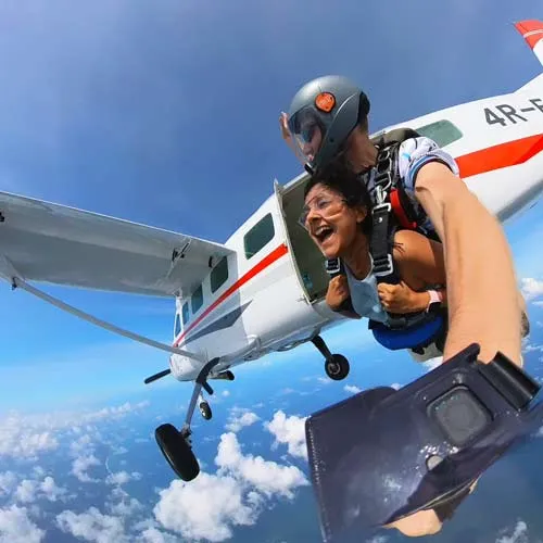passenger and skydiving instructor jumping out of plane in sri lanka